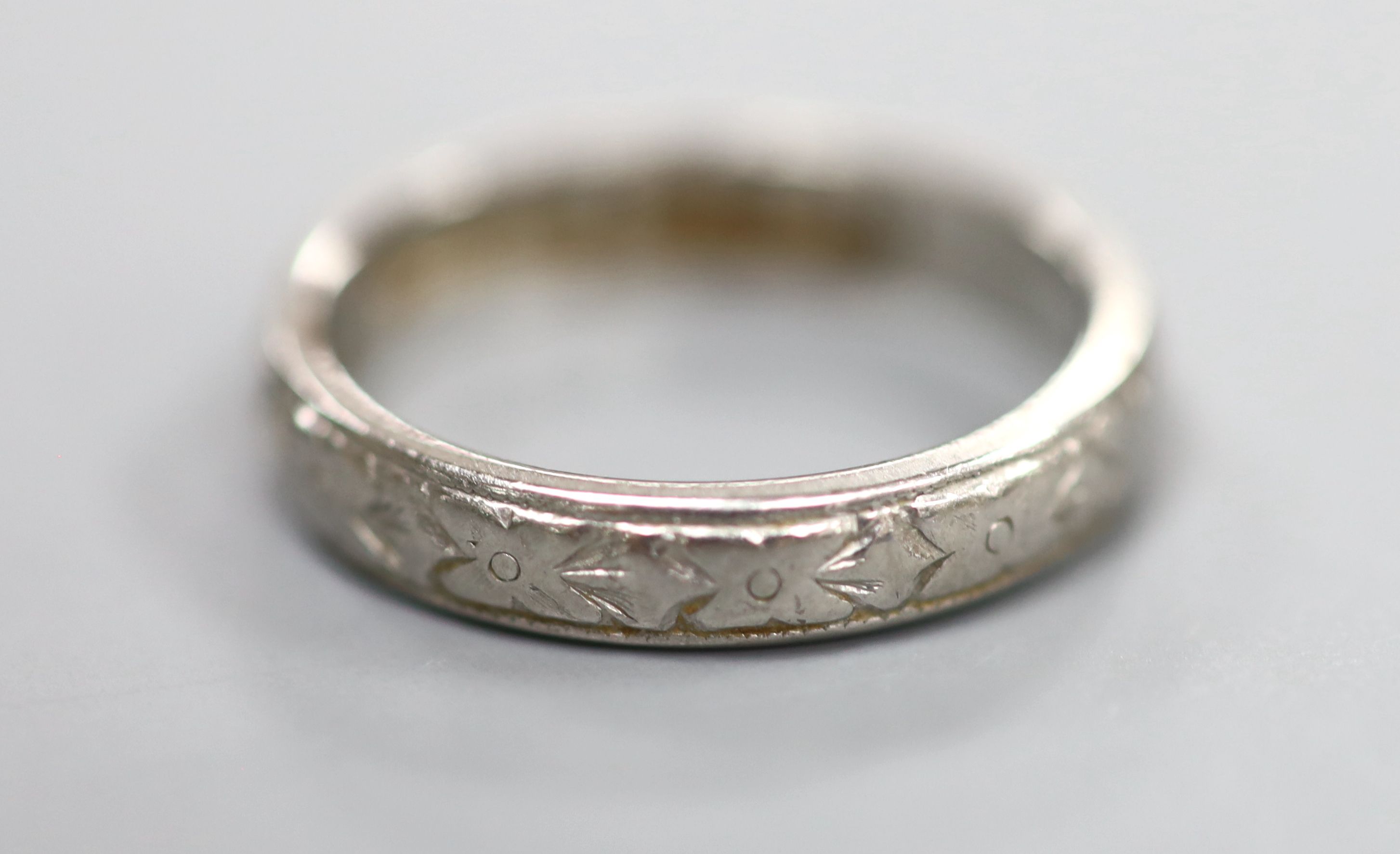 An engraved white metal(stamped platinum) wedding band, size L,